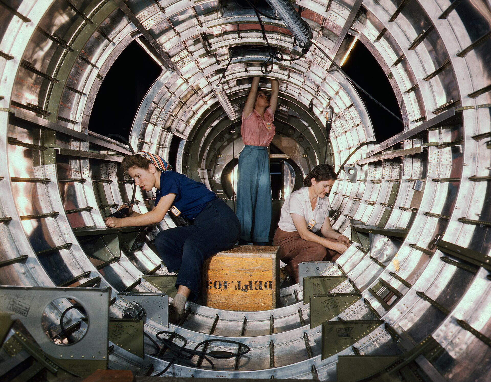 Two women working inside the ribbed tail fuselage of a B-17F bomber at the Douglas plant in Long Beach, 1942