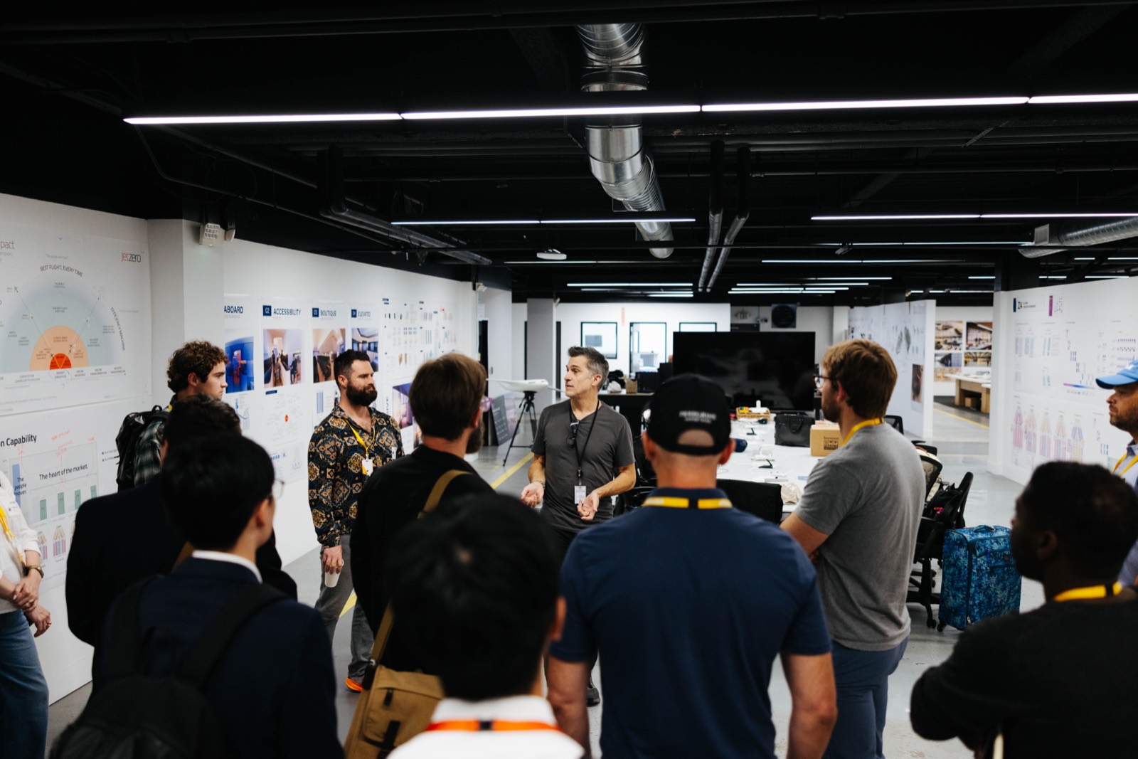 A tour group gathered around a guide inside JetZero's engineering space