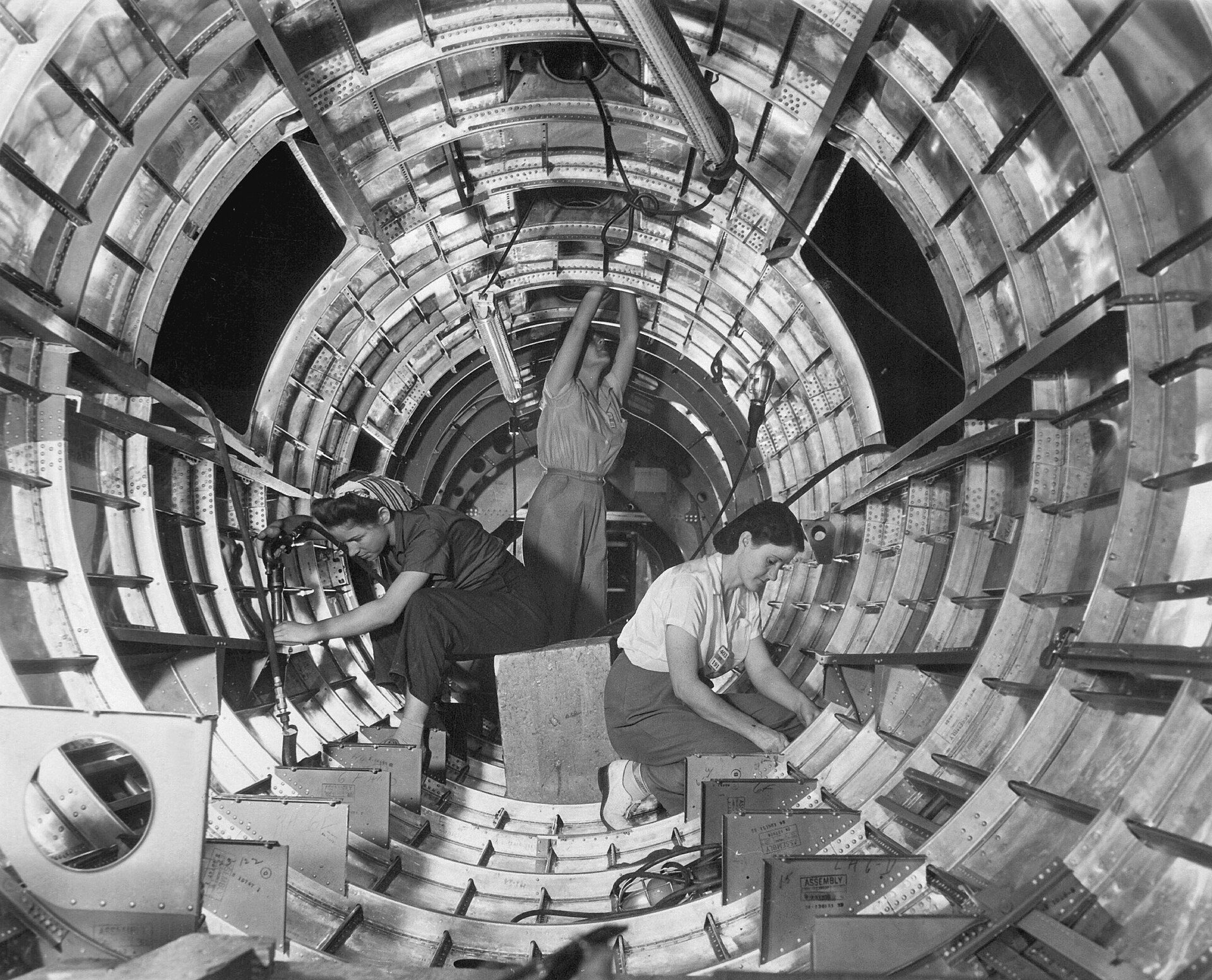 Women workers installing fixtures inside the tail section of a B-17F bomber at the Long Beach plant